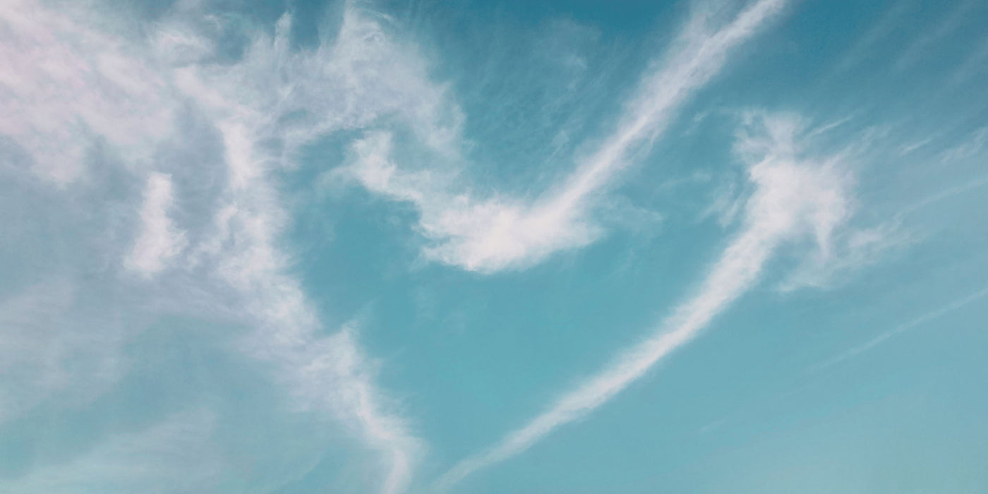 Clouds making a heart shape against a blue sky