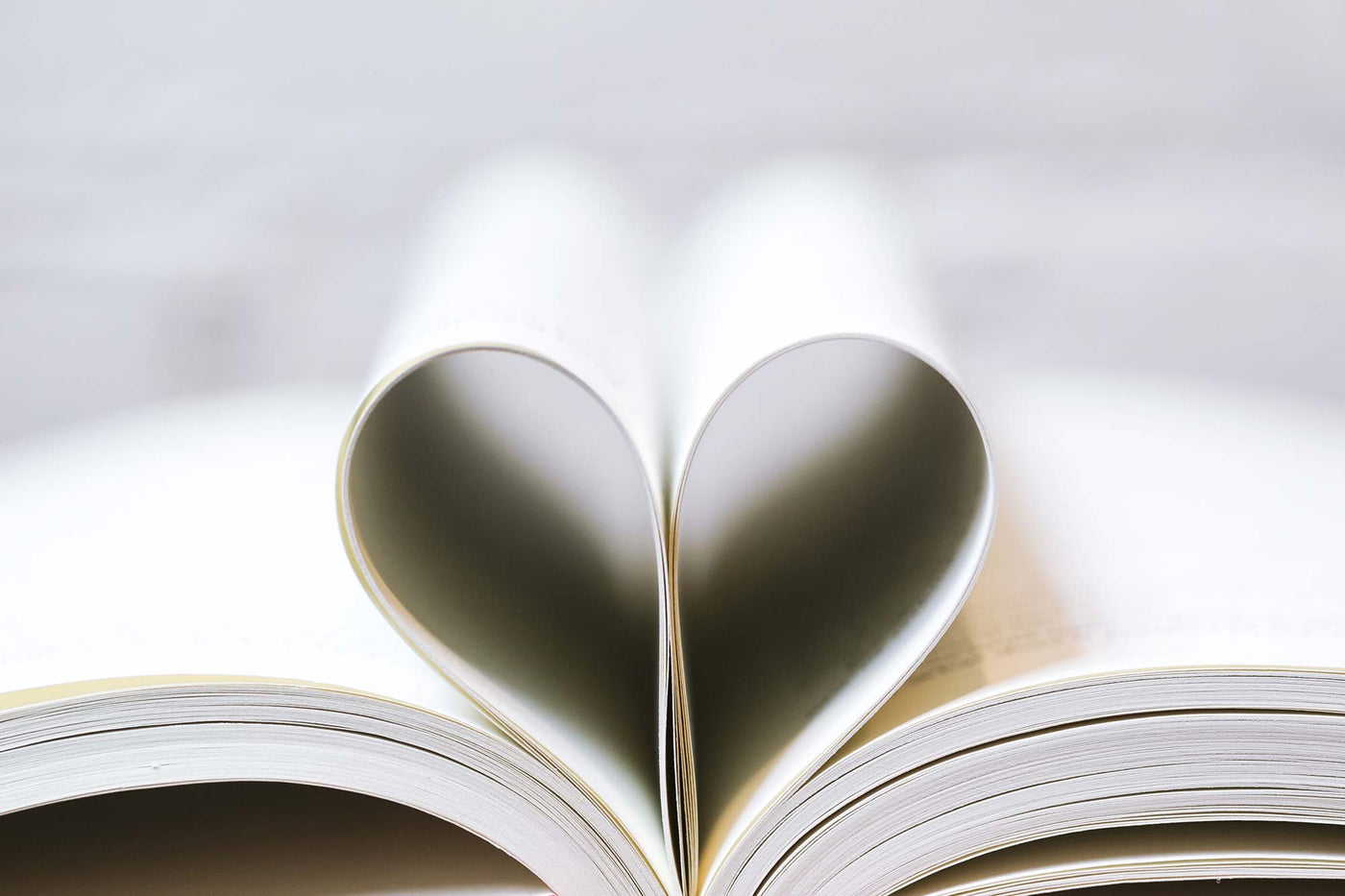 A book with the central pages tucked in to form the shape of a heart